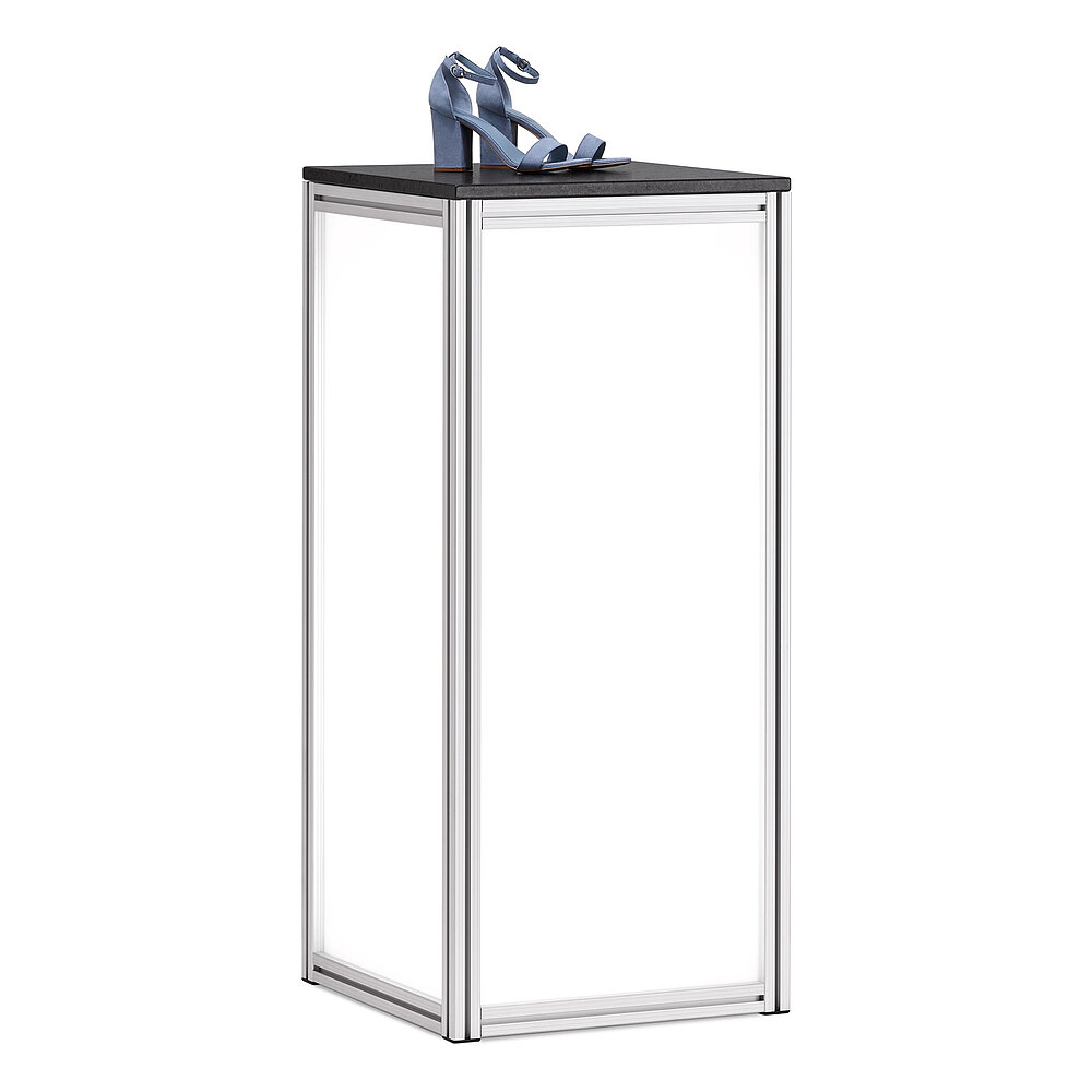 a square, column-shaped table made of aluminium profiles, with milky-transparent side panes illuminated from within, and black natural stone table top, on it placed a pair of blue high-heeled shoes, isolated on white background